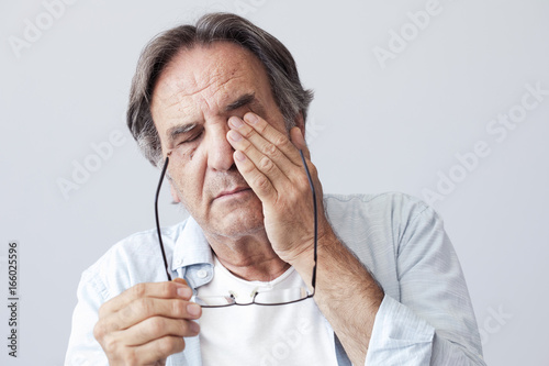 Old man with eye fatigue