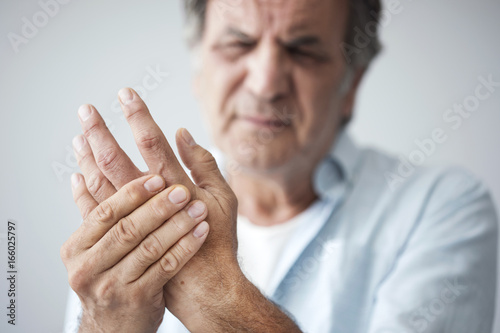 Old man with finger pain photo