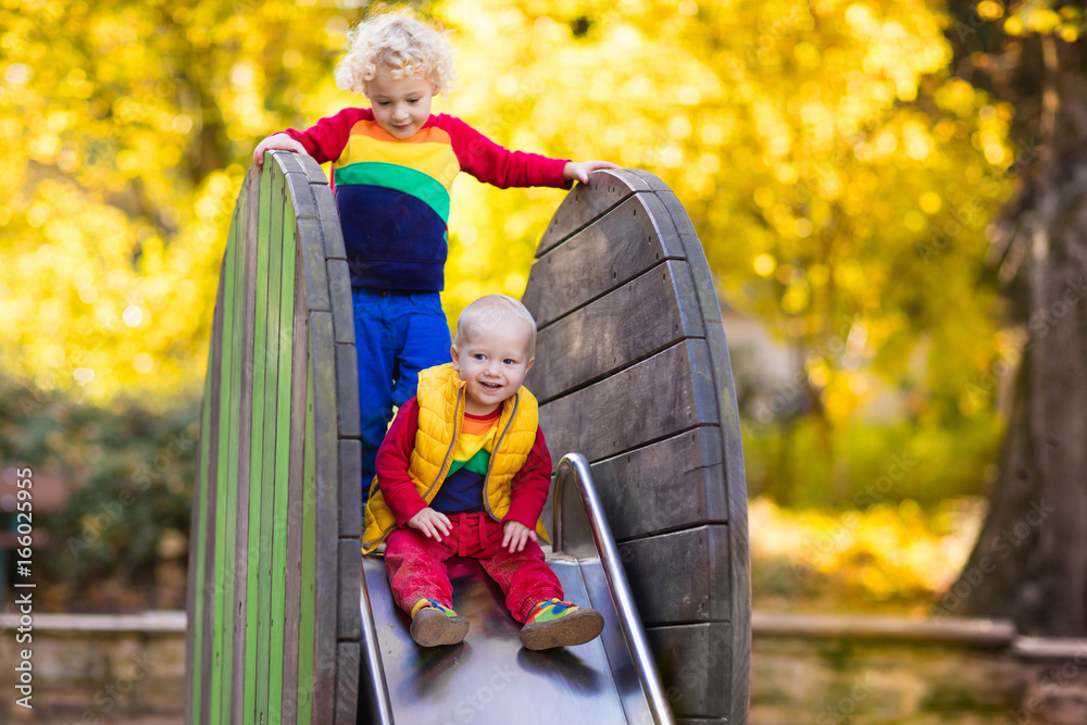 Child on playground in autumn. Kids in fall. Child on playground in autumn. Kids in fall.