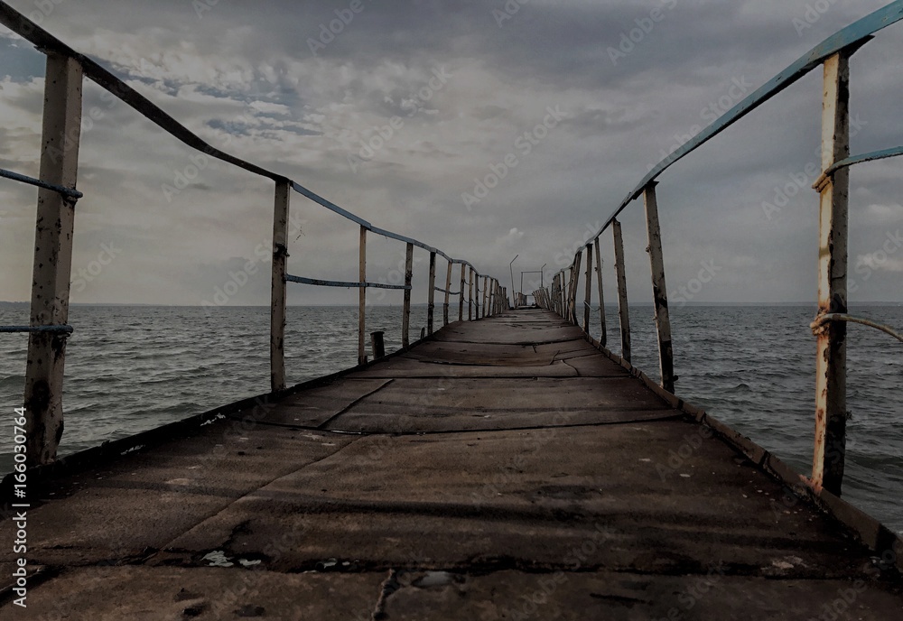 The old gloomy abandoned wooden bridge