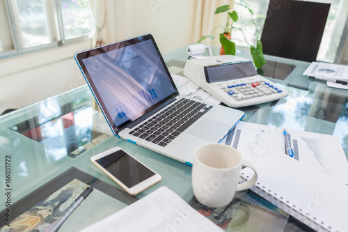 Open laptop and accessories with coffee cup for home workplace