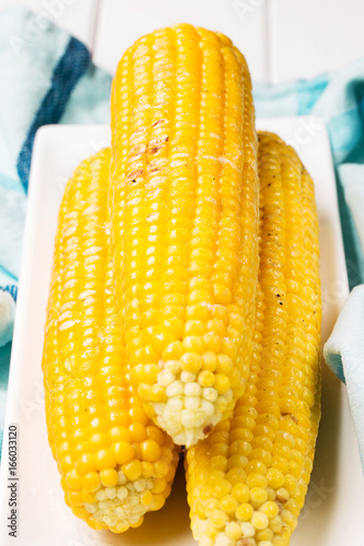 Grilled corn with salt and butter, vertical, selective focus