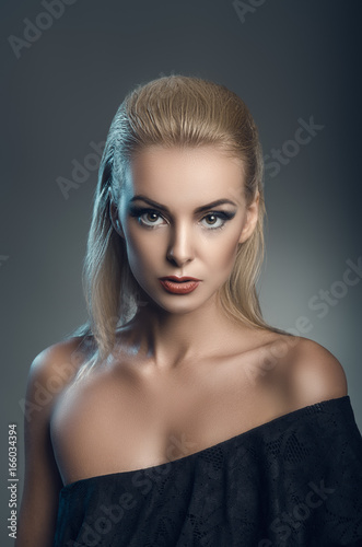 fashion studio portrait of young beautiful woman on dark background