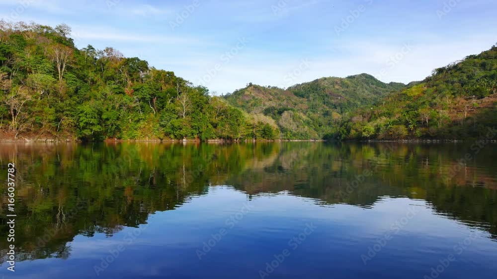 A real time clip showing the scenic delights of the mountain lake Balanan in Negros Oriental, Philippines. The lake is quite calm, so it beautifully mirrors the surroundings. A real time clip showing the scenic delights of the mountain lake Balanan in Negros Oriental, Philippines. The lake is quite calm, so it beautifully mirrors the surroundings.