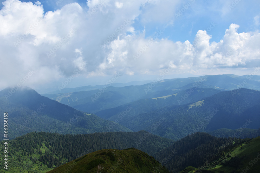 Fototapeta premium Clouds over mountains, mountain ranges, summer tourism