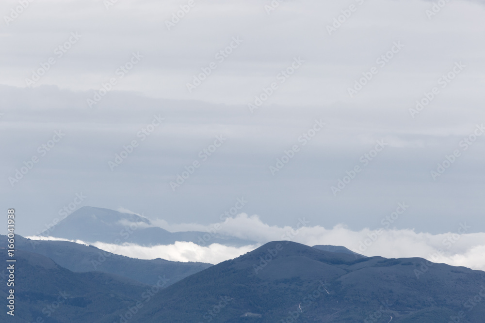 Distant hills and mountains with clouds and fog between them
