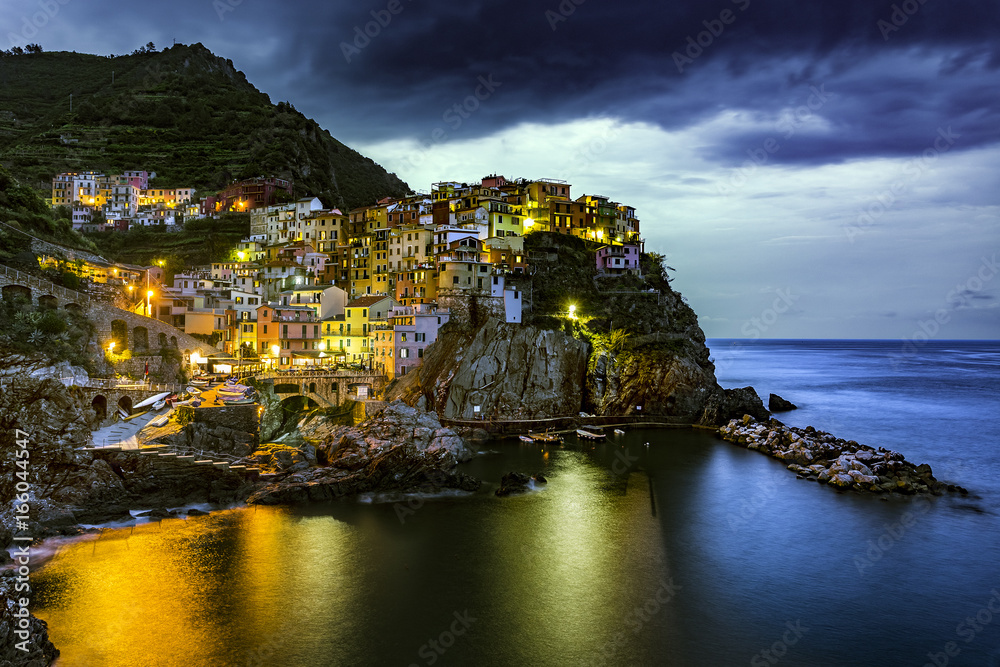 Italy. Cinque Terre (UNESCO World Heritage Site since 1997). Manarola town by night (Liguria region)