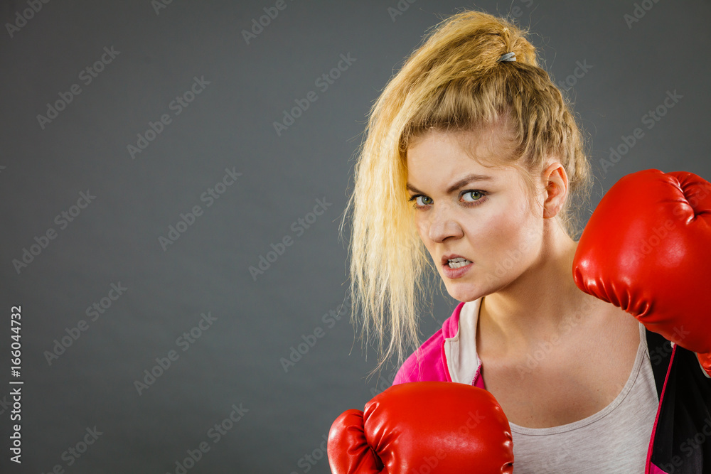 Angry woman wearing boxing gloves Angry woman wearing boxing gloves