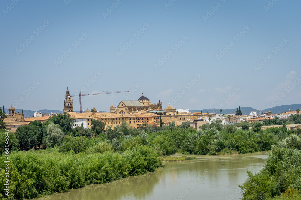 The bell tower and Cathedral mosque of Cordoba from the bridge on the river Guadalquivir