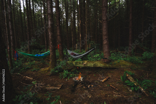 Camping in the rainforest with hammock and campfire