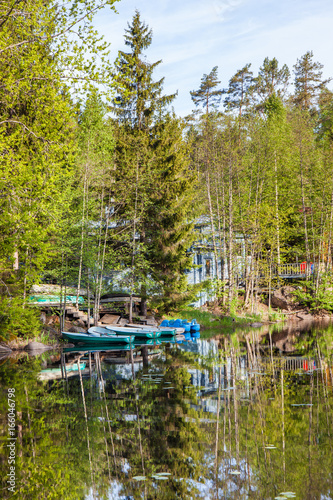 Boats near the forest shore of the lake in Karelia