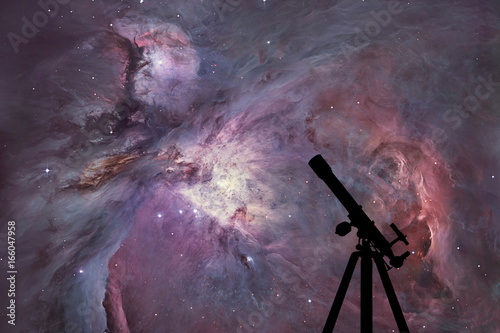 Fototapeta Naklejka Na Ścianę i Meble -  Space background with silhouette of telescope. The Orion Nebula Messier 42 diffuse nebula  in constellation Orion.