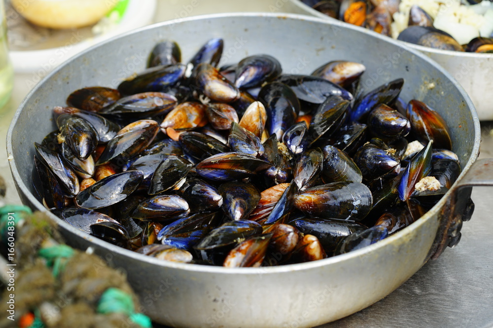 Cooking mussels in a large pan Cooking mussels in a large pan