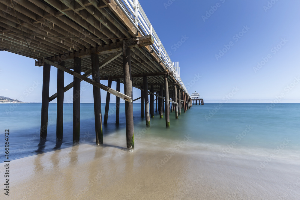 Malibu Pier Beach with motion blur pacific ocean water near Los Angeles in Southern California.  