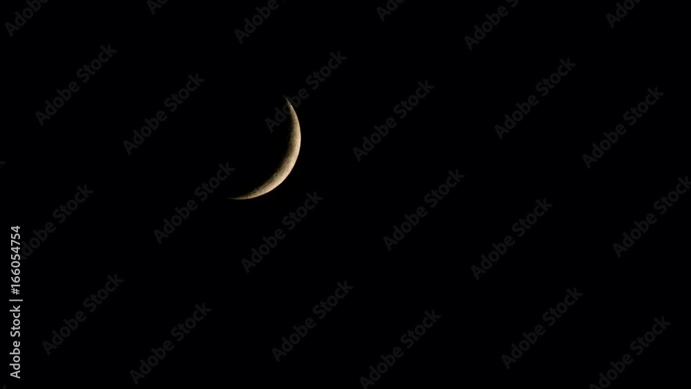 New moon in the pitchblack sky. Long shot
