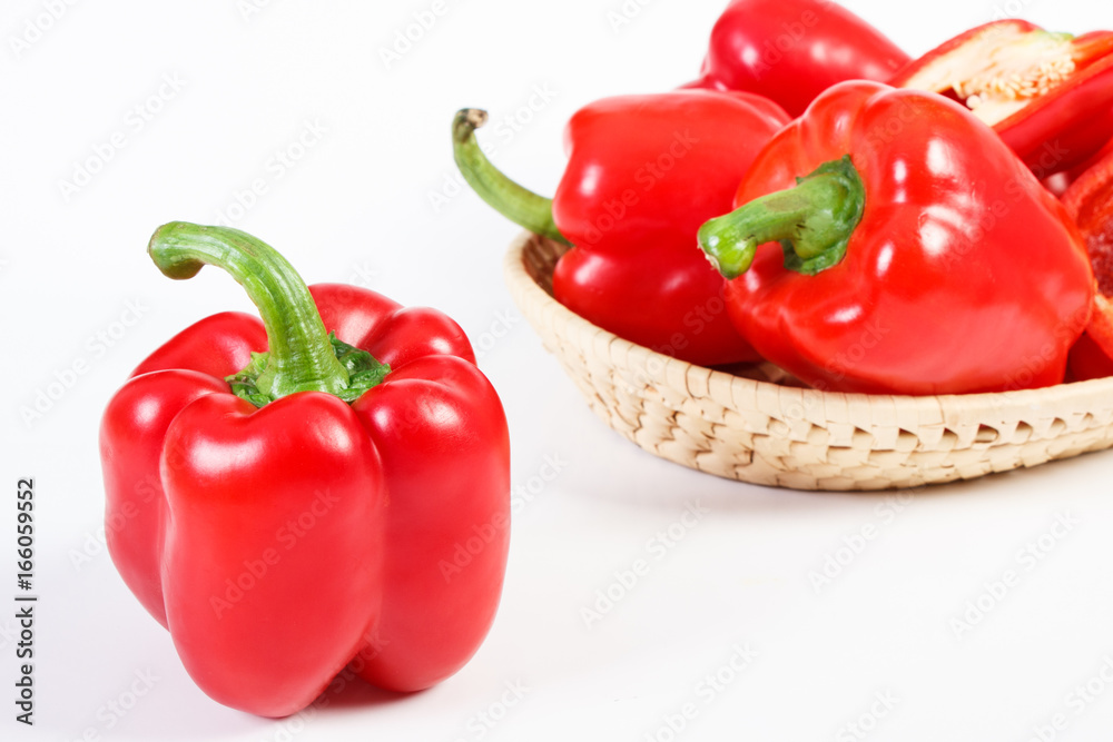 Red ripe peppers with wicker basket on white background, healthy nutrition Red ripe peppers with wicker basket on white background, healthy nutrition