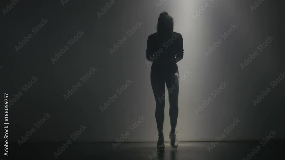 A young woman steps quickly in one place. The film focuses on her entire body as she rapidly takes her steps. A young woman steps quickly in one place. The film focuses on her entire body as she rapidly takes her steps.