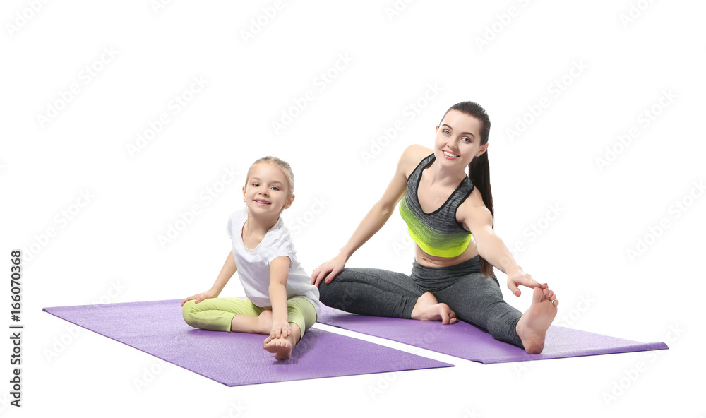 Mother and daughter doing exercise on white background