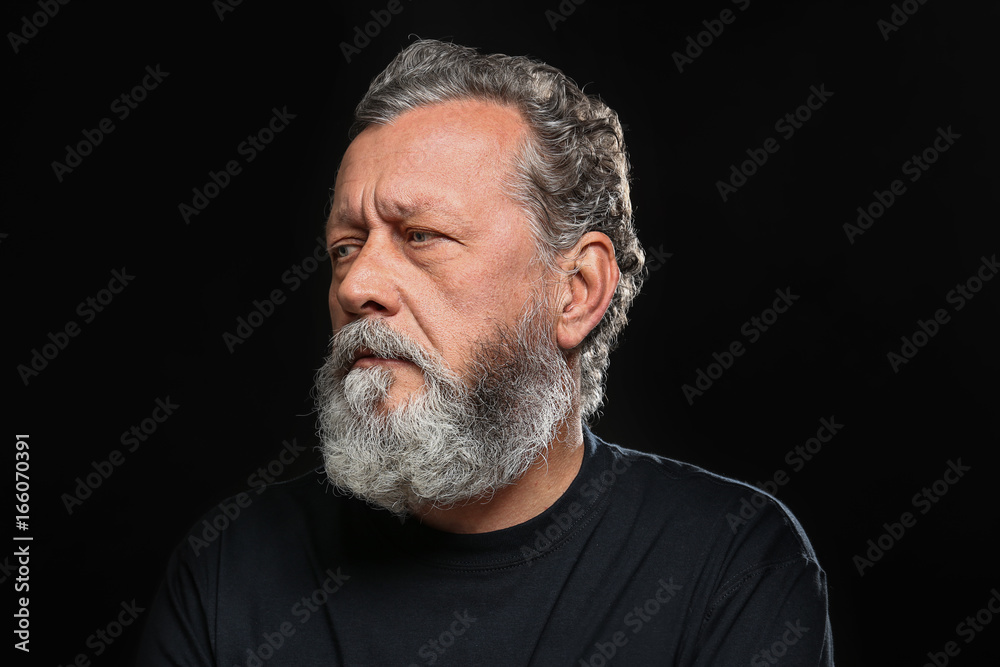 Obraz premium Handsome elderly man on black background