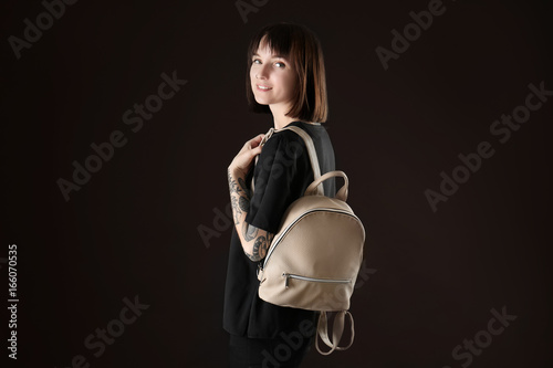 Young woman with leather ba...