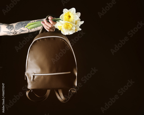 Woman holding leather backp...
