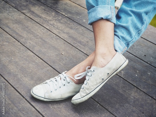 Legs of woman with sneakers