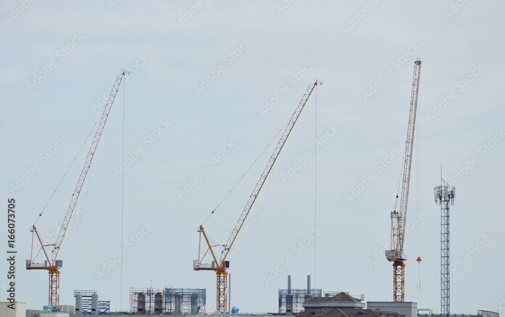 heavy crane on roof top of under construction building heavy crane on roof top of under construction building