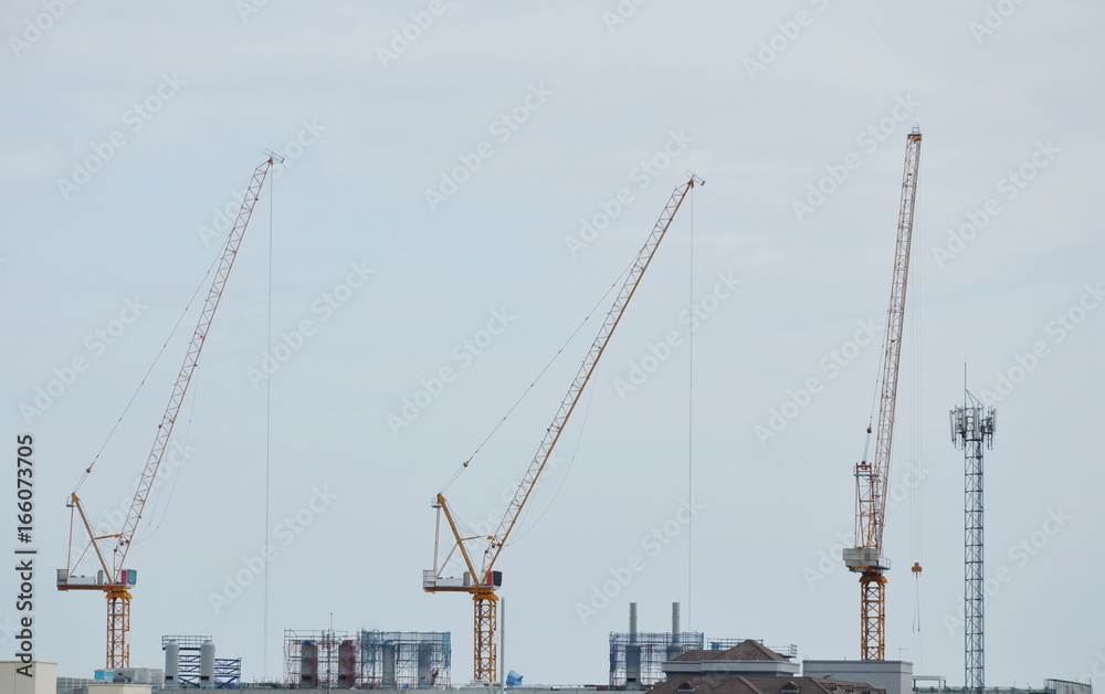 heavy crane on roof top of under construction building