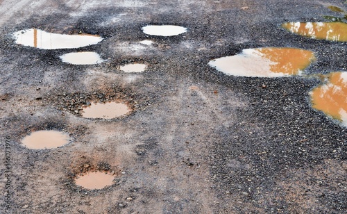 many hole on asphalt road in countryside in rainy season