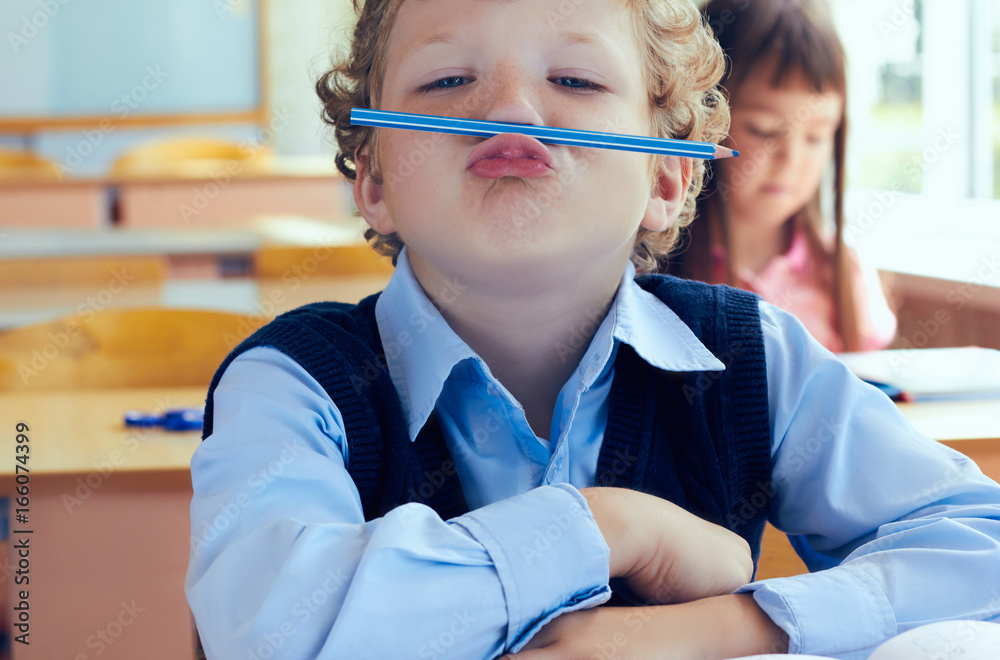 Schoolboy has fun between lessons in primary school. Schoolboy has fun between lessons in primary school.
