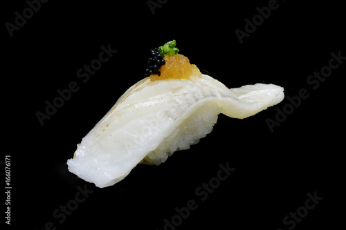 Aburi Engawa Sushi, torched flatfish on rice topping with Spring onion and minced daikon and caviar. Japanese tradition cuisine with black isolated background

