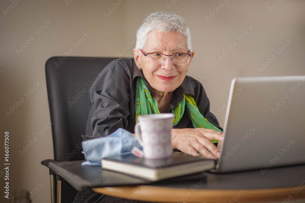 Senior lady having fun browsing internet content online Senior lady having fun browsing internet content online