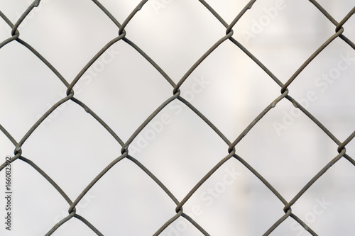 Fence grid close up, blurred background of the grey color