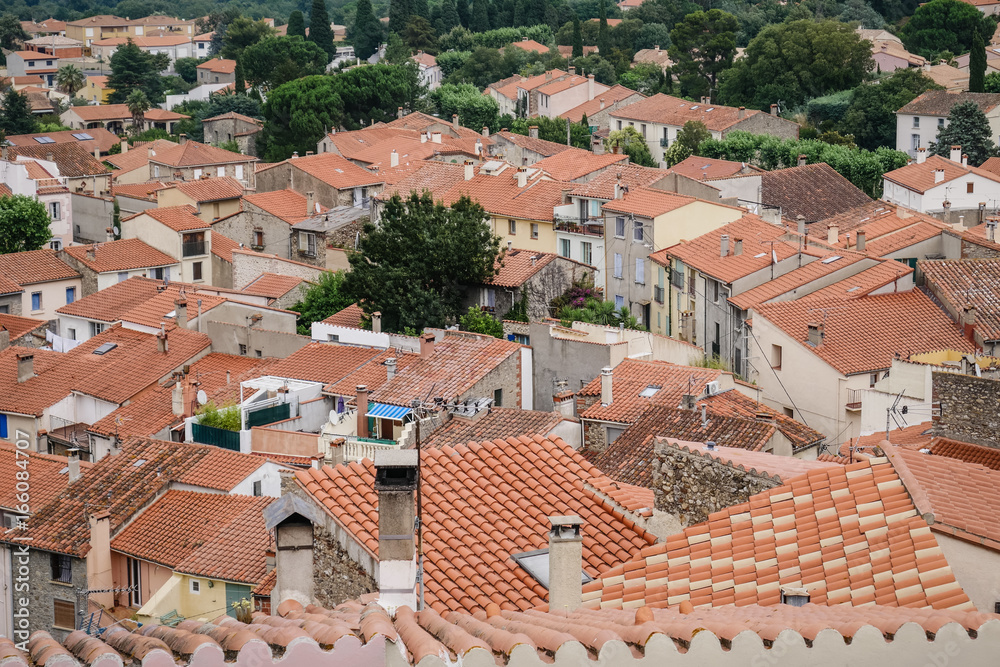 View of traditional and typical small village with red-tiled roofs in south of France