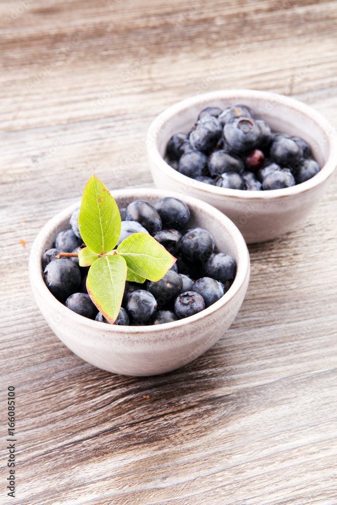 Freshly picked blueberries in wooden bowl. Juicy and fresh blueb Freshly picked blueberries in wooden bowl. Juicy and fresh blueb