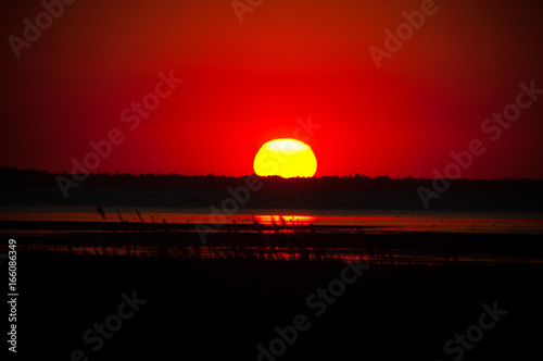 Red sunset near pond