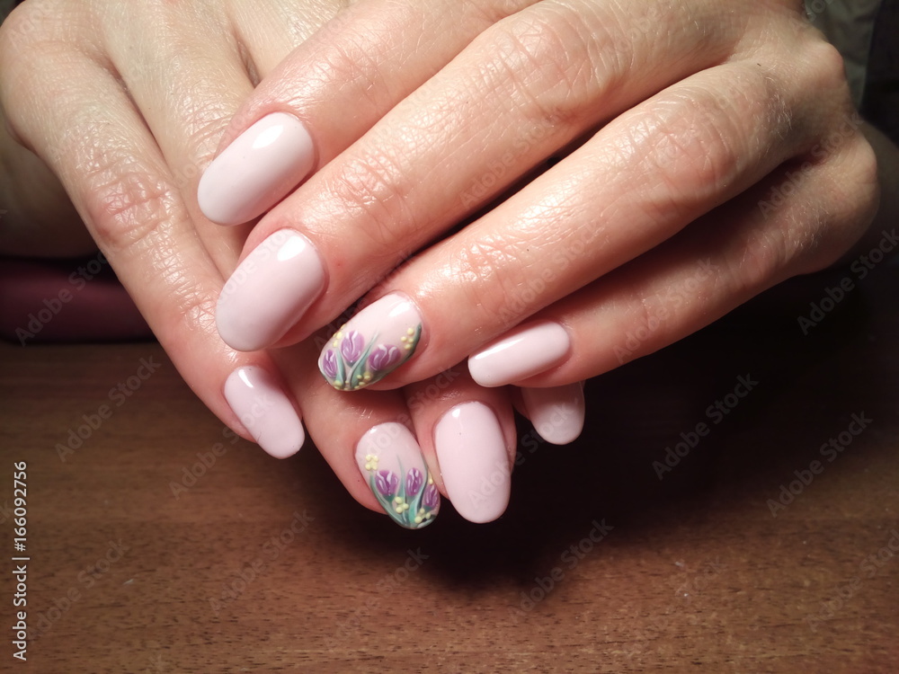 The manicurist excellently made her work a beautiful manicure with a polish gel on her hands and the client is happy The manicurist excellently made her work a beautiful manicure with a polish gel on her hands and the client is happy