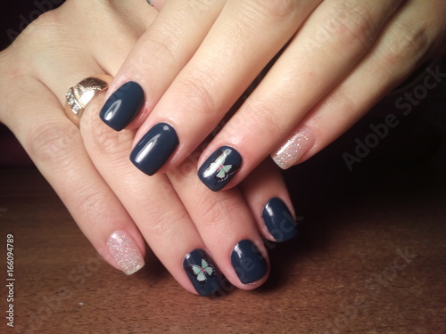 The manicurist excellently made her work a beautiful manicure with a polish gel on her hands and the client is happy