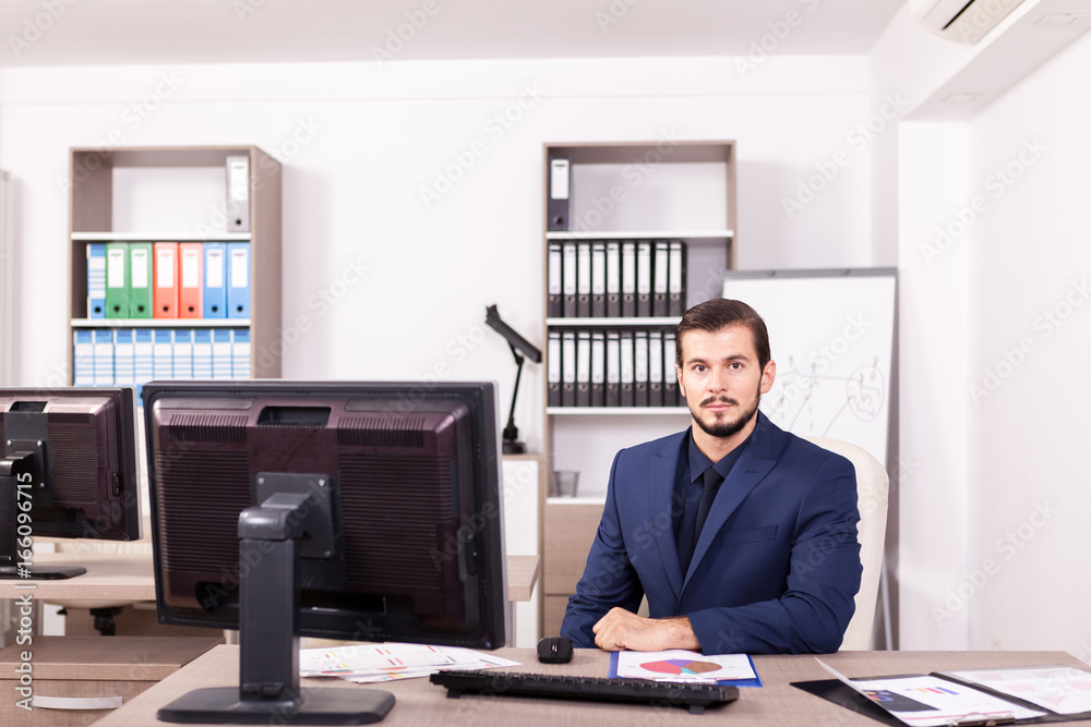 Businessman in suit working in his office. Business and corporate. Image of young succesful entrepreneur at his work place. Businessman in suit working in his office. Business and corporate. Image of young succesful entrepreneur at his work place.