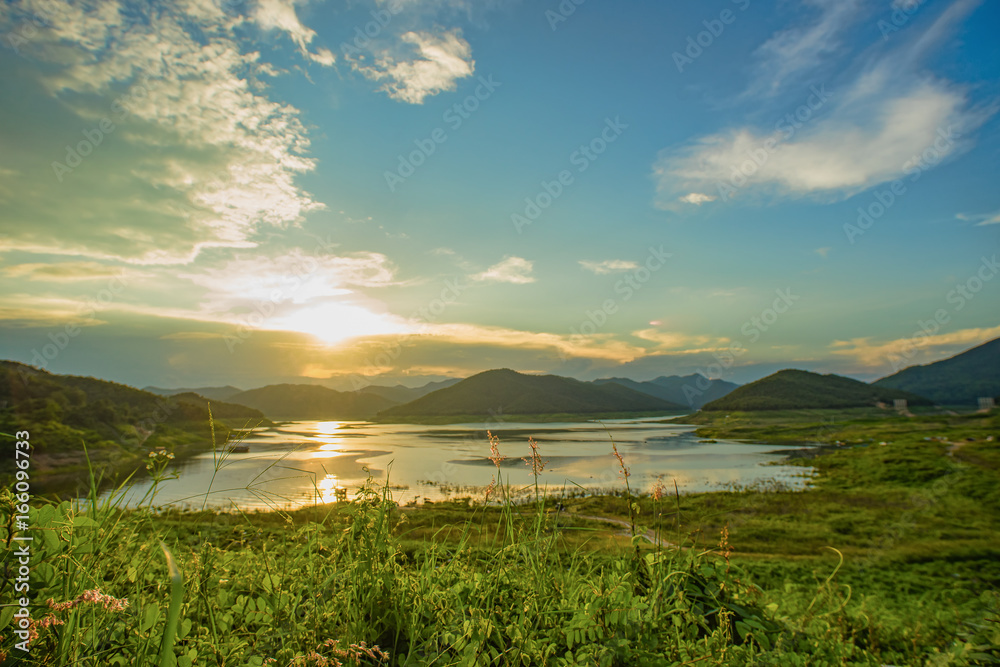 Fototapeta premium Calm River, Mountains, and clouds.