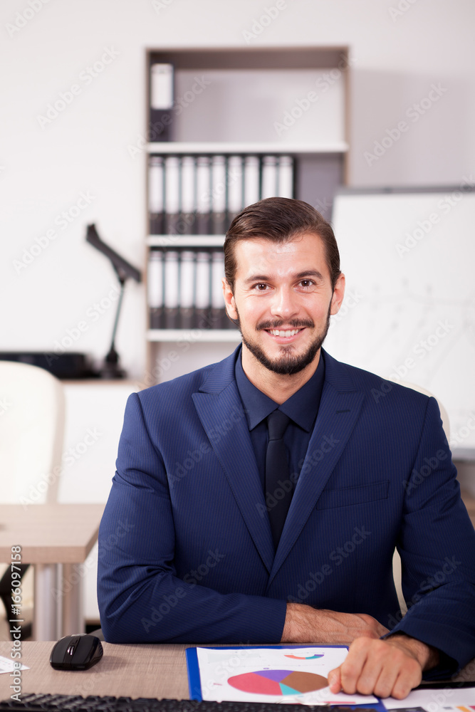 Professional Businessman in suit working in his office. Business and corporate. Image of young succesful entrepreneur at his work place. Professional Businessman in suit working in his office. Business and corporate. Image of young succesful entrepreneur at his work place.
