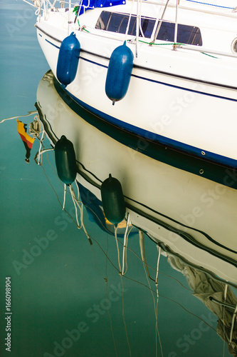 Sport yacht boat side reflecting in water photo