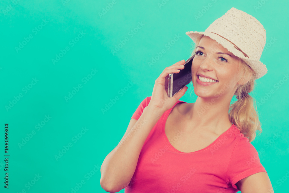 Tourist woman with sun hat talking on phone Tourist woman with sun hat talking on phone