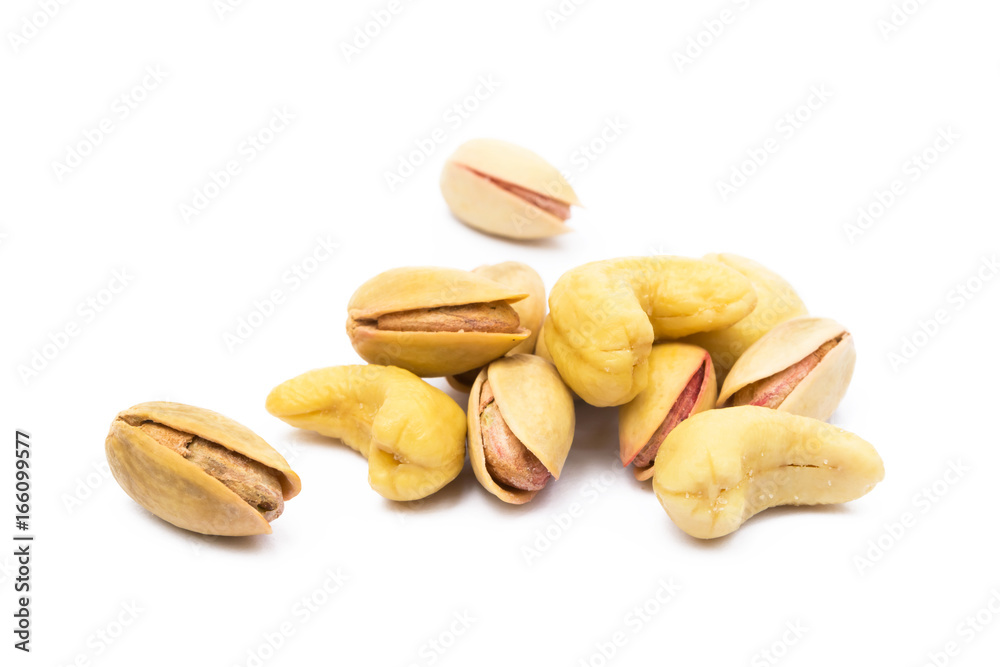 Pile of roasted pistachios and cashew isolated on white background Pile of roasted pistachios and cashew isolated on white background