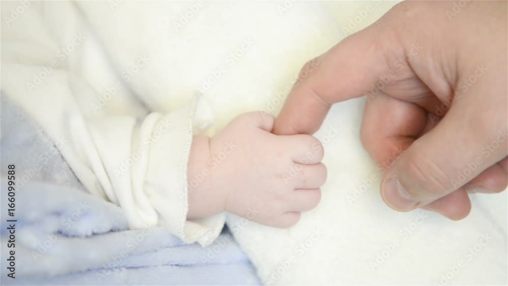 Father holds newborn infant baby's hand for the first time. Father holds newborn infant baby's hand for the first time.