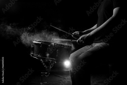The man is playing snare drum.