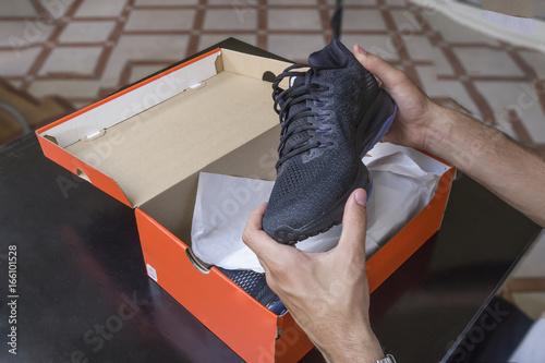 Opening the box of a new pair of shoes