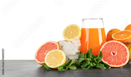 Fototapeta Naklejka Na Ścianę i Meble -  Jug of fresh lemonade with citrus fruits on white background