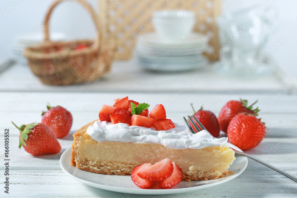 Piece of cake with cream and strawberries on plate Piece of cake with cream and strawberries on plate