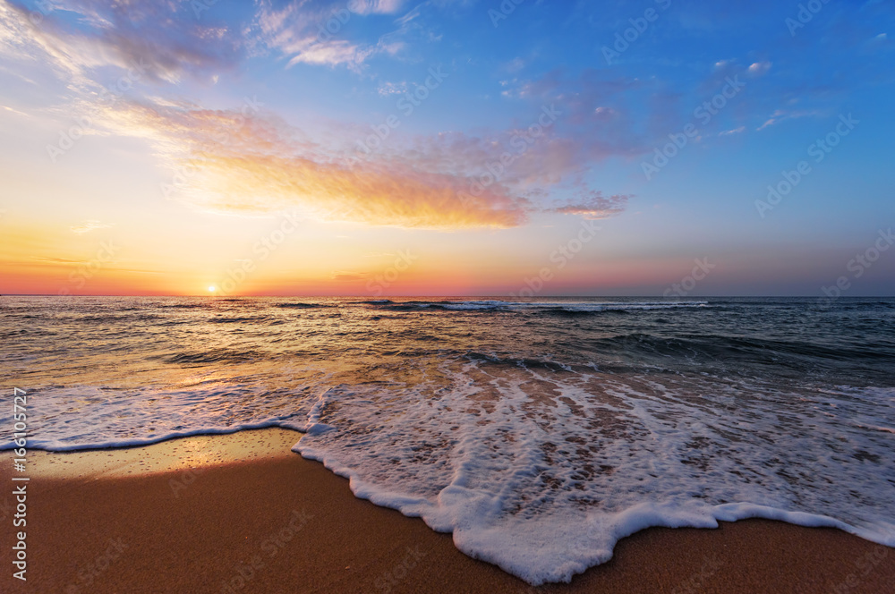 Golden sunrise sunset over the sea ocean waves.